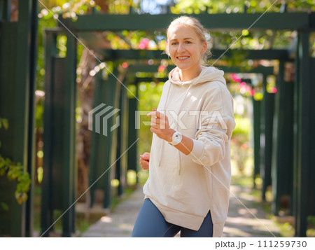 idea of healthy lifestyle and sports in a modern city. Female jogger. Fit young Caucasian woman running in park and enjoying healthy outdoor. Fitness girl in public park. idea of healthy lifestyle and sports in a modern city. Female jogger. Fit young Caucasian woman running in park and enjoying healthy outdoor. Fitness girl in public park. 111259730