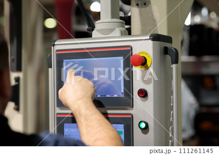 operator working with touchscreen control panel 111261145