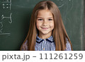 AI-generated content. little girl portrait smile, face little schoolgirl, little student educational institution, 7 years old, child kid girl sitting desk smile, team work, friends classmates, work 111261259