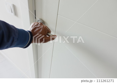 Man's Hand Opening door close up  111261271