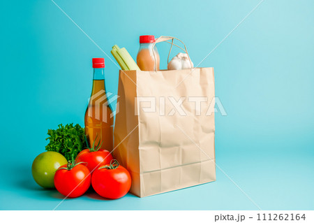 Craft brown shopping paper bag and grocery on blue background. Delivery concept 111262164