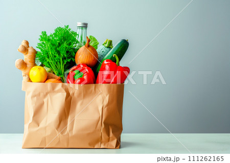 Craft brown shopping paper bag and grocery on blue background. Delivery concept 111262165