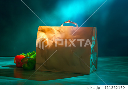 Craft brown shopping paper bag on blue background with soft Sfumato lightening. Craft brown shopping paper bag on blue background with soft Sfumato lightening. 111262170