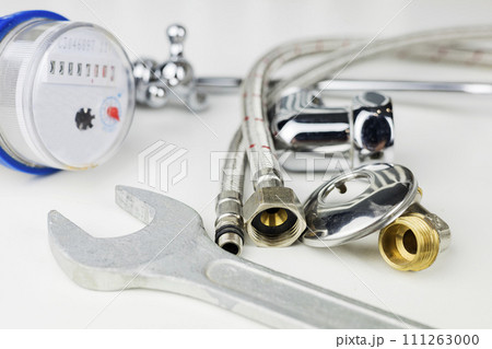 Plumbing parts, accessories and tools on a white background with copy space. 111263000