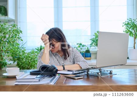 Sad upset business woman sitting at workplace with computer 111263600