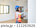 Professional woman home Inspector surveyor wearing vests and hard hat at new property 111263626