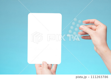 Close-up round acne patch on finger on blue background. Acne patches for treatment of pimple and rosacea close-up. Facial rejuvenation cleansing cosmetology Close-up round acne patch on finger on blue background. Acne patches for treatment of pimple and rosacea close-up. Facial rejuvenation cleansing cosmetology 111263786