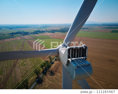 Aerial view of wind turbine in countryside area, Wind power plants in agricultural landscape, Green energy from renewable sources concept Aerial view of wind turbine in countryside area, Wind power plants in agricultural landscape, Green energy from renewable sources concept 111265467