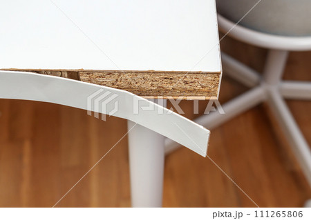 Broken office desk with cracked surface. Close up Broken office desk with cracked surface. Close up 111265806