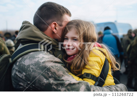 A soldier in camouflage returned home from war and hugs his daughter 111268722