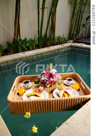 Set of floating breakfast tray in swimming pool. Breakfast in swimming pool, floating breakfast set in tray 111268768