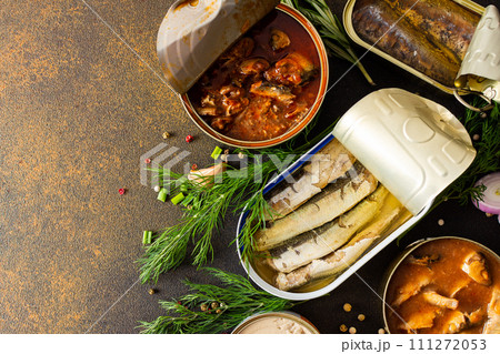 Open tin cans with canned fish Open tin cans with canned fish 111272053