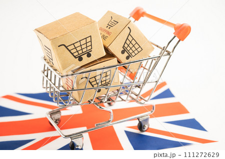 Box with shopping online cart logo and United Kingdom flag, Import Export commerce finance delivery trade. Box with shopping online cart logo and United Kingdom flag, Import Export commerce finance delivery trade. 111272629