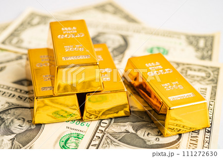 Gold bar on US dollar banknotes money and graph, economy finance exchange trade investment concept. Gold bar on US dollar banknotes money and graph, economy finance exchange trade investment concept. 111272630