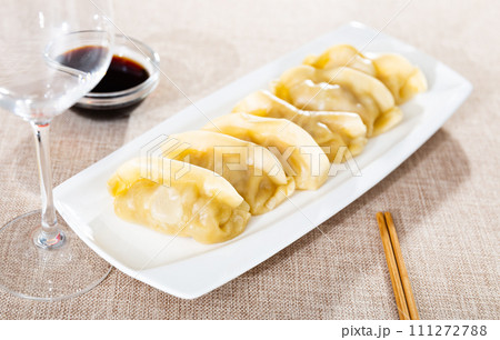 Delicious boiled gyoza dumplings, supplemented with necessary chopsticks and spicy soy sauce 111272788