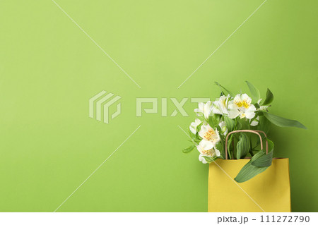 Paper bag for shopping with flowers, on a green background. 111272790