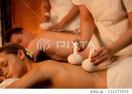 Hot herbal ball spa massage body treatment with couple customer. Quiescent Hot herbal ball spa massage body treatment with couple customer. Quiescent 111273910