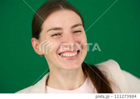 Young woman doing gestucilation wiyh her face, her show one teeth Young woman doing gestucilation wiyh her face, her show one teeth 111273984