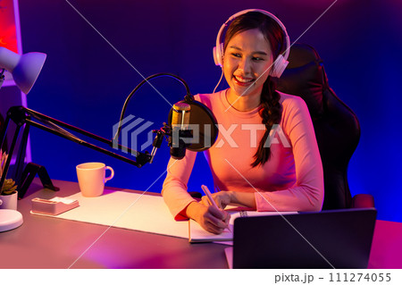 Smiling creative young beautiful Asian influencer talking in channel. Stratagem. Smiling creative young beautiful Asian influencer talking in channel. Stratagem. 111274055