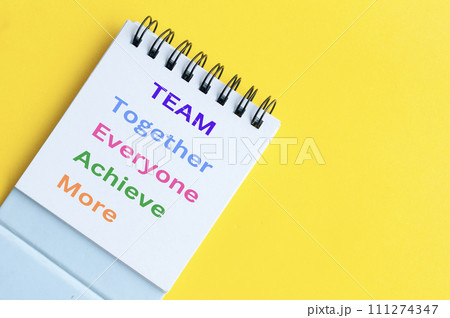 Team representing together, everyone achieve more. Team word on notepad on yellow background 111274347