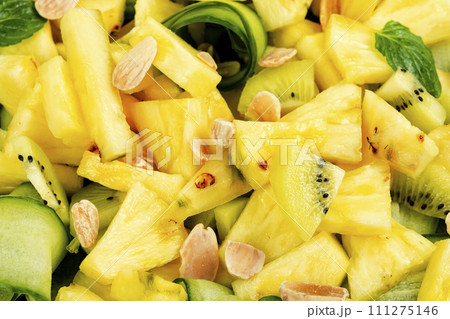 Juicy pineapple and cucumber salad, close up. 111275146