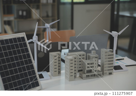 Close-up at tablet, Engineers pointing at tablet with their hands. To jointly design the use of renewable energy with wind and solar energy. Concept of using renewable energy. Close-up at tablet, Engineers pointing at tablet with their hands. To jointly design the use of renewable energy with wind and solar energy. Concept of using renewable energy. 111275907