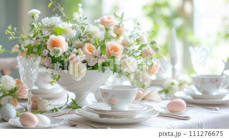 An elegant Easter brunch table featuring exquisite china and delicate floral arrangements 111276675