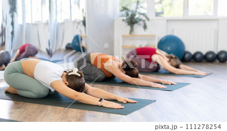 Group of women doing yoga in studio Group of women doing yoga in studio 111278254