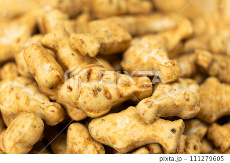 A treat for cats and kittens is a fish-shaped catnip cookie close-up. A treat for cats and kittens is a fish-shaped catnip cookie close-up. 111279605