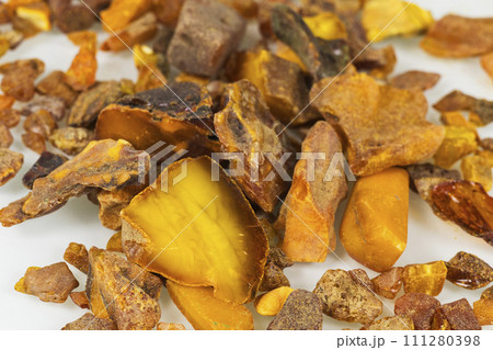 Yellow and orange raw amber pieces of different shapes. Raw materials for jewelry. 111280398