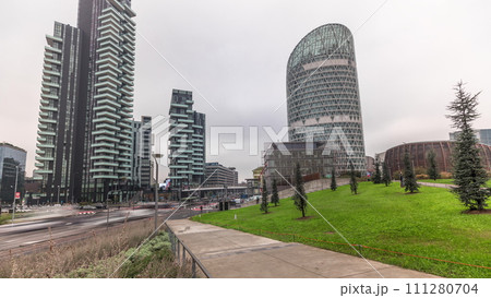 Panorama showing skyscrapers and biblioteca from park with green lawn timelapse in Milan Panorama showing skyscrapers and biblioteca from park with green lawn timelapse in Milan 111280704