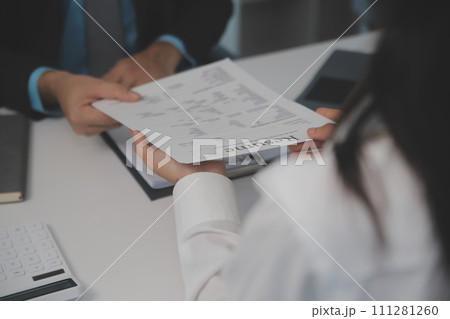 Close up view of job interview in office, focus on resume writing tips, employer reviewing good cv of prepared skilled applicant, recruiter considering application, hr manager making hiring decision 111281260
