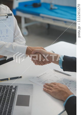 Close up view of job interview in office, focus on resume writing tips, employer reviewing good cv of prepared skilled applicant, recruiter considering application, hr manager making hiring decision 111281270