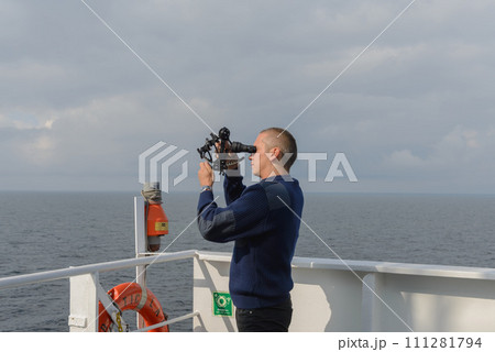 Seaman with sextant on navigational bridge Seaman with sextant on navigational bridge 111281794