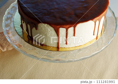 Decadent Chocolate Ganache Drizzle on a Classic Cheesecake 111281991