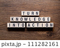 Turn knowledge into action - word concept on building blocks, text 111282161