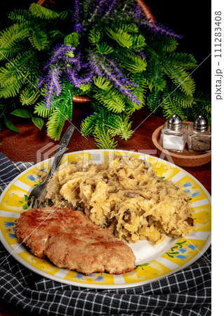 Minced meat cutlet with boiled sauerkraut. Minced meat cutlet with boiled sauerkraut. 111283408