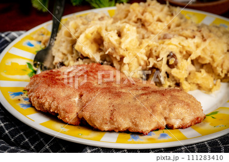 Minced meat cutlet with boiled sauerkraut. Minced meat cutlet with boiled sauerkraut. 111283410