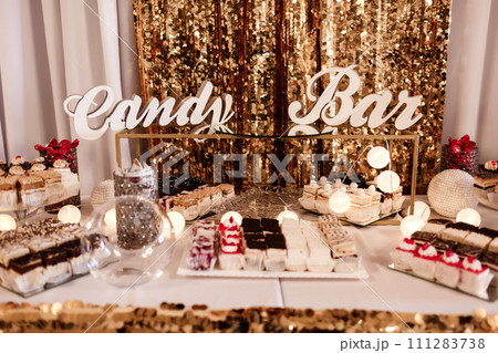 Delicious sweet buffet with cupcakes. Sweet holiday buffet with cupcakes and other desserts. Candy Bar. Delicious sweet buffet with cupcakes. Sweet holiday buffet with cupcakes and other desserts. Candy Bar. 111283738