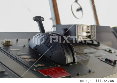 Navigational control panel with hand. Ship engine control. Navigational bridge. Navigational control panel with hand. Ship engine control. Navigational bridge. 111283786