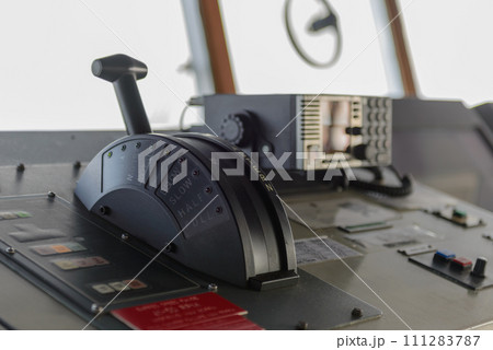 Navigational control panel with hand. Ship engine control. Navigational bridge. Navigational control panel with hand. Ship engine control. Navigational bridge. 111283787