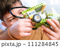Little boy makes robot toy car. Smart boy assemble constructor kids workshop. Smart child science class robotics kids technology child constructor robotics learning and development kids stem education 111284845