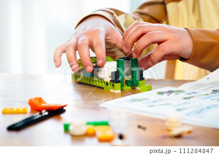 Close up hands child playing constructor pieces building instruction assemble constructor robotics kids technology child constructor kids stem education robotics child. Technology toys science 111284847