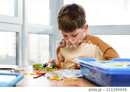 Smart boy assemble constructor. Smart child reading instruction constructor robotics kids technology child constructor kids stem education robotics child science technology toys tech education game 111284848