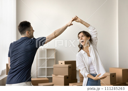 Cheerful young boyfriend and girlfriend beginning living together Cheerful young boyfriend and girlfriend beginning living together 111285263