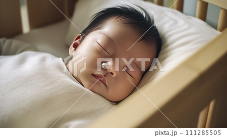 portrait of a charming sleeping baby with a cute teddy bear on a comfortable bed. 111285505