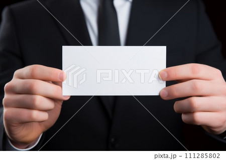 Person in black suit showing blank business card Person in black suit showing blank business card 111285802