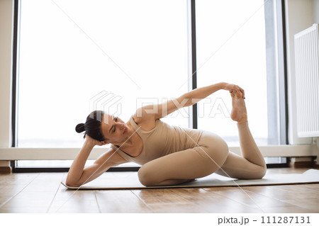 Caucasian lady doing achieving advanced Mermaid Pose. Caucasian lady doing achieving advanced Mermaid Pose. 111287131