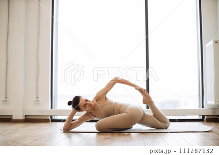 Caucasian lady doing achieving advanced Mermaid Pose. Caucasian lady doing achieving advanced Mermaid Pose. 111287132