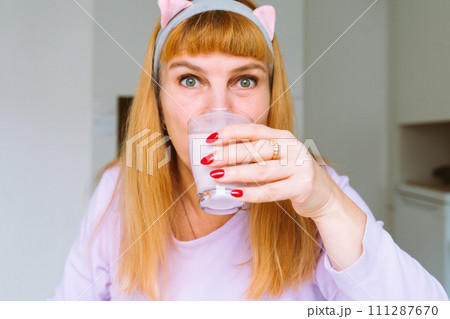 Middle aged woman drinking yogurt 111287670